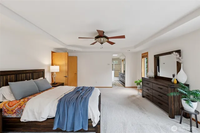 a bedroom with a bed and dresser with mirror