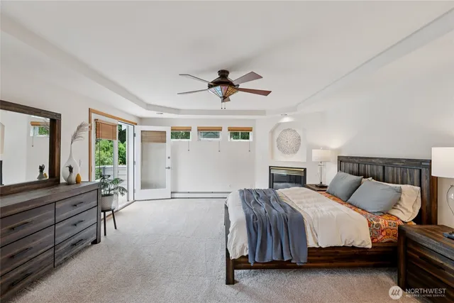 a spacious bedroom with a bed and a chandelier
