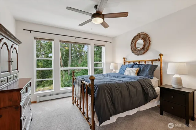 a bedroom with a bed and a large window