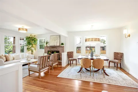 a living room with fireplace furniture and a wooden floor