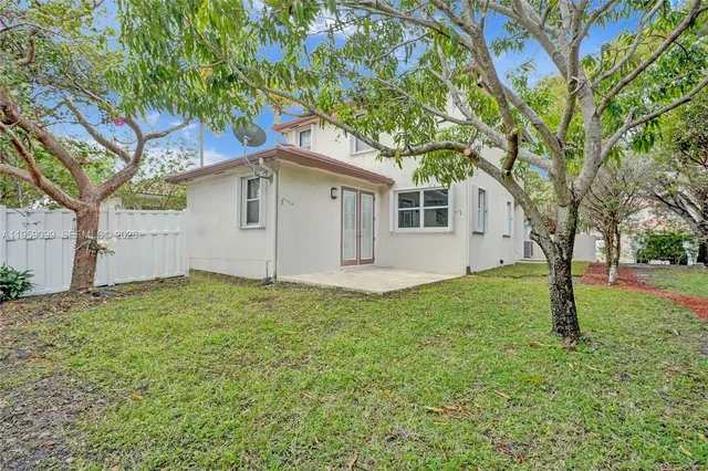 a house that has a tree in front of the house