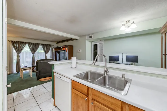 a kitchen with a sink and a refrigerator