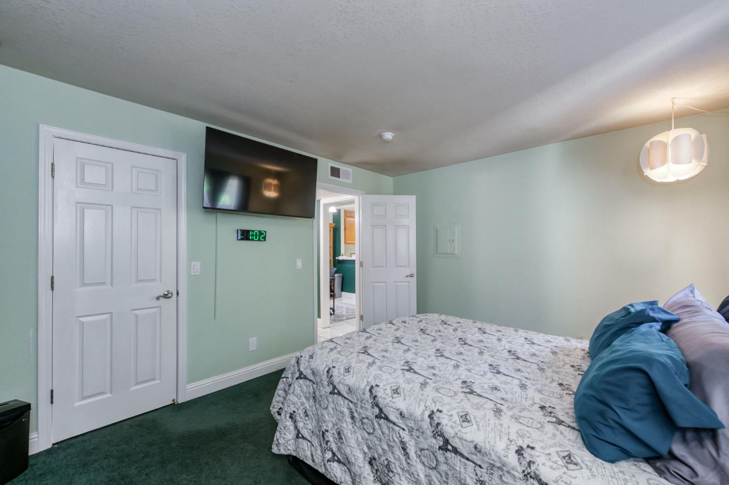 2909 Huntington Boulevard, Unit 145 Fresno, CA 93721 - Photo 13 of 33 a bedroom with a bed and a flat screen tv