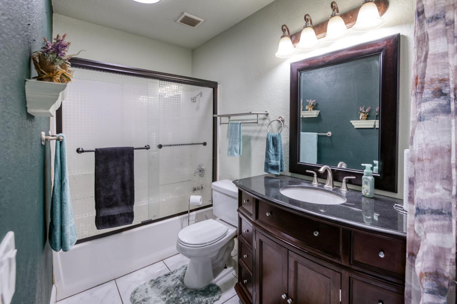 2909 Huntington Boulevard, Unit 145 Fresno, CA 93721 - Photo 14 of 33 a bathroom with a sink a toilet and shower