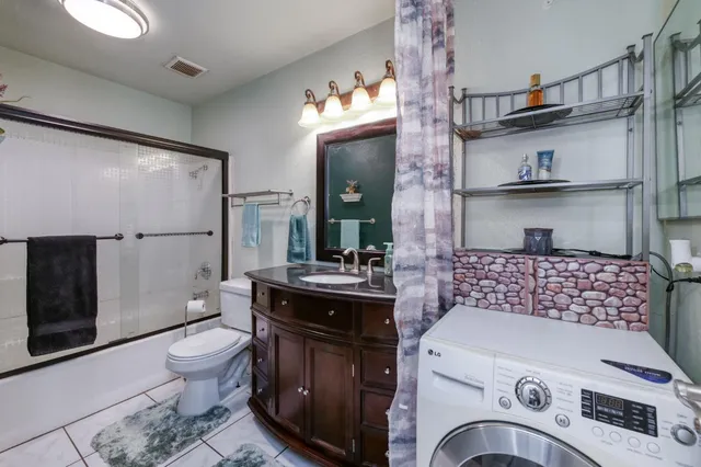 a bathroom with a sink a toilet and a shower