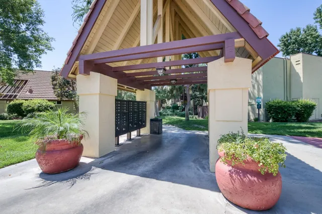 a view of a patio with table and chairs potted plants