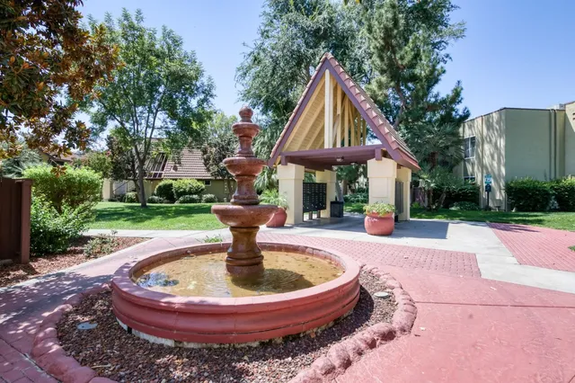 a backyard of a house with table and chairs