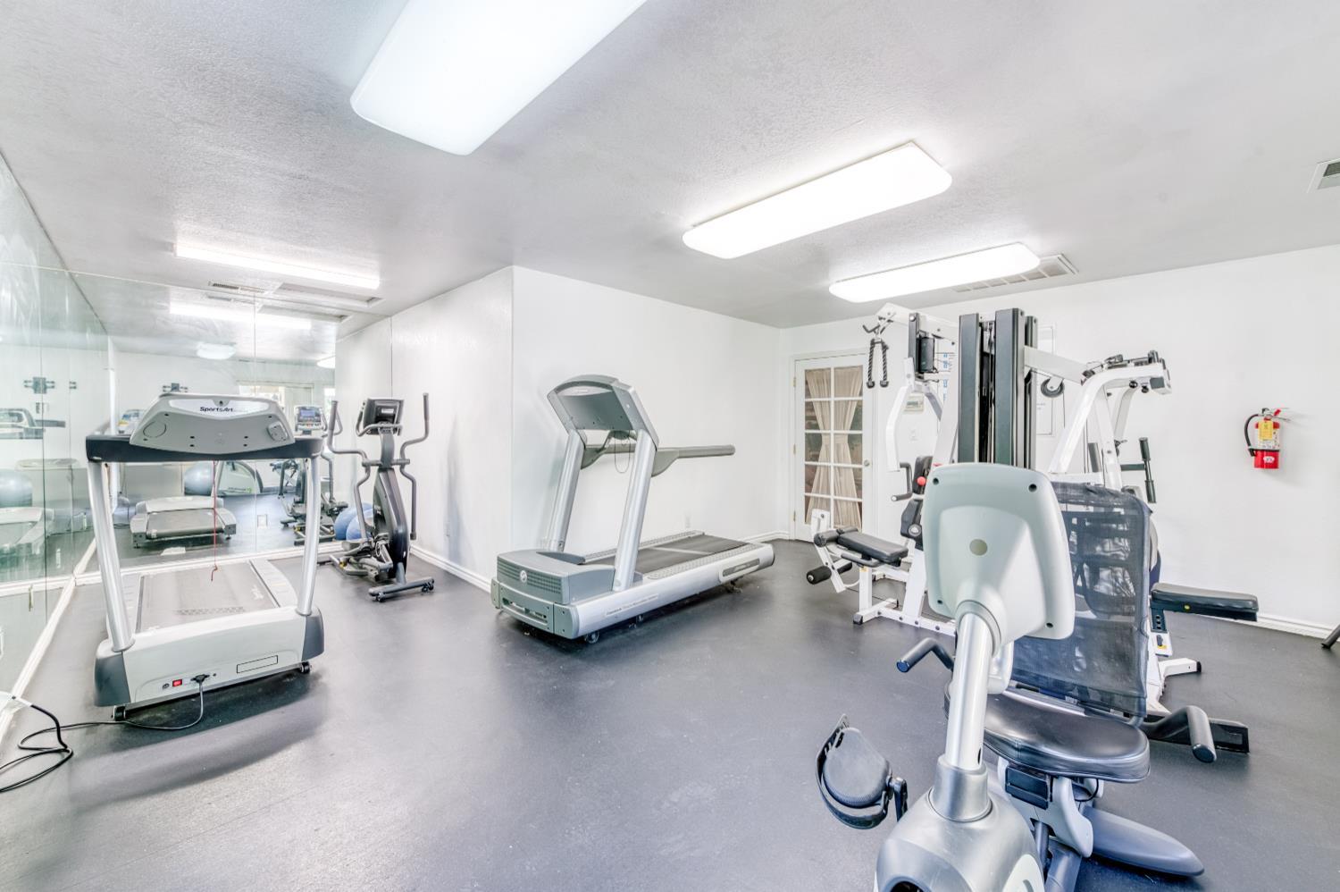 2909 Huntington Boulevard, Unit 145 Fresno, CA 93721 - Photo 26 of 33 a view of a room with gym equipment