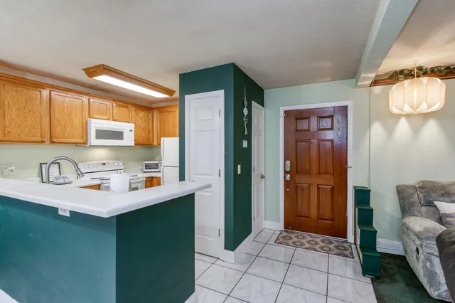 a kitchen with stainless steel appliances a sink stove and refrigerator