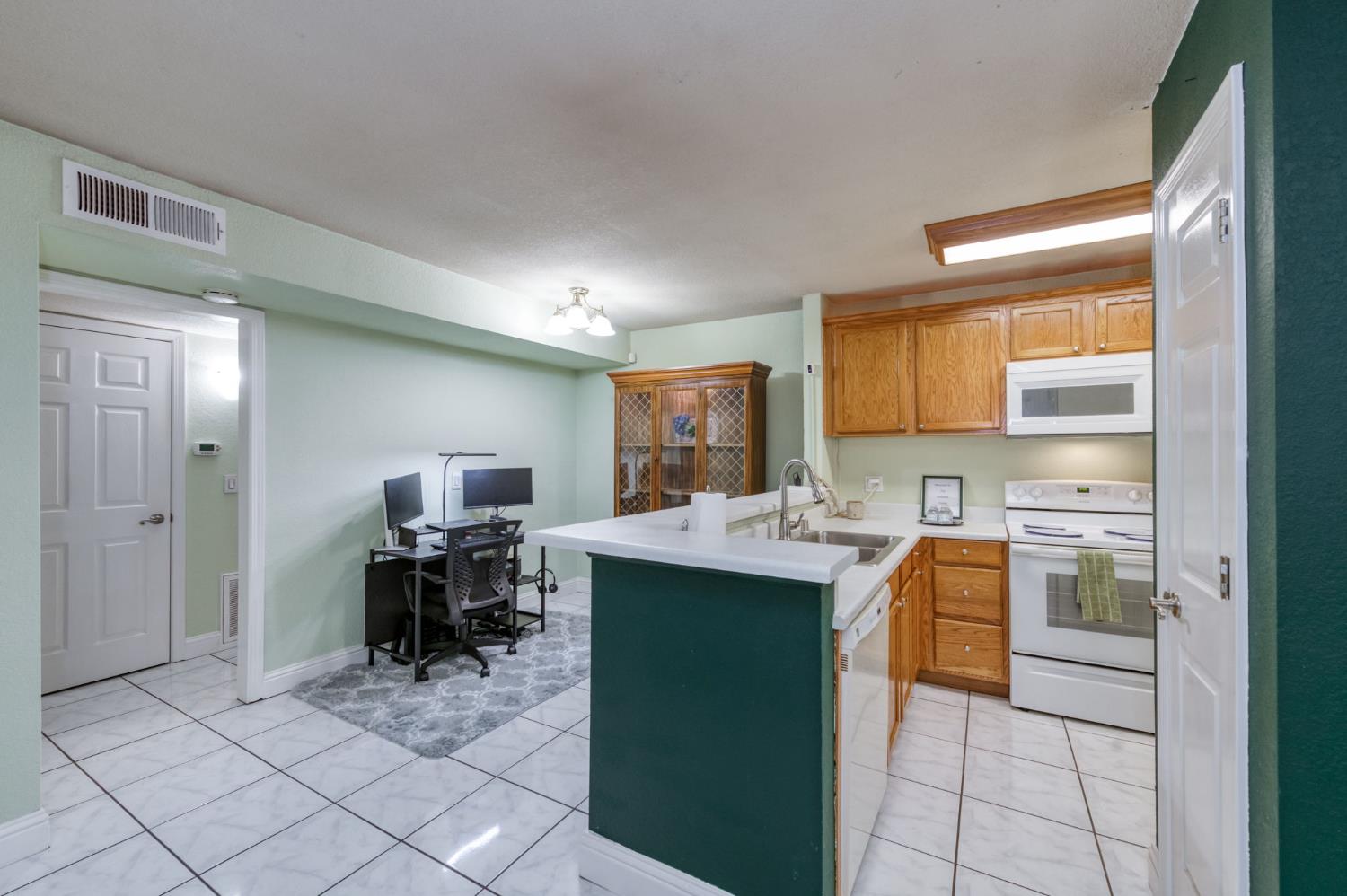 2909 Huntington Boulevard, Unit 145 Fresno, CA 93721 - Photo 6 of 33 a kitchen with a sink cabinets and wooden floor