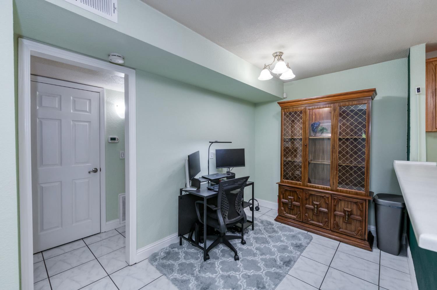 2909 Huntington Boulevard, Unit 145 Fresno, CA 93721 - Photo 8 of 33 a workspace with chandelier