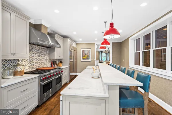 a kitchen with stainless steel appliances kitchen island granite countertop a stove a sink and a refrigerator
