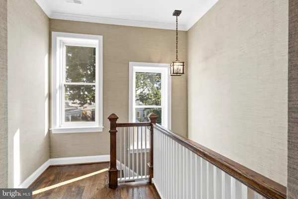a bedroom with a bed chandelier and a window