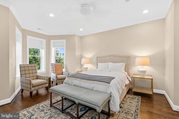 a bedroom with a large bed and a window