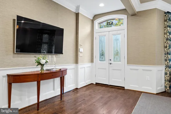 a living room with furniture chandelier and view of kitchen