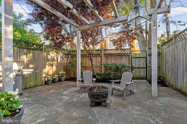 a building outdoor space with patio furniture and potted plants