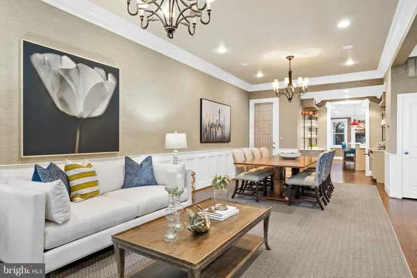 a view of a dining room with furniture wooden floor and chandelier