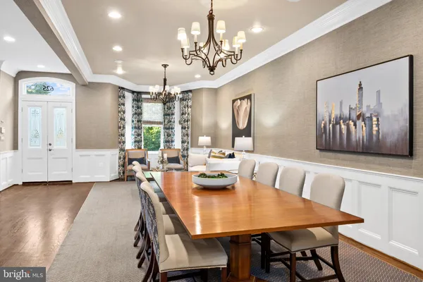 a view of a dining room with furniture and chandelier