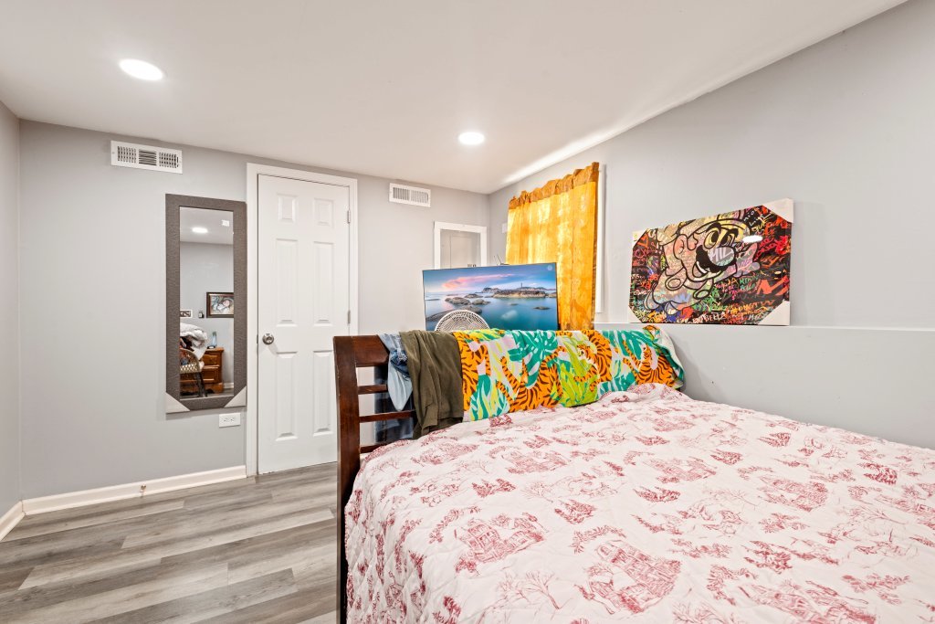 14564 Spaulding Avenue Harvey, IL 60426 - Photo 12 of 20 a bedroom with a bed and wooden floor