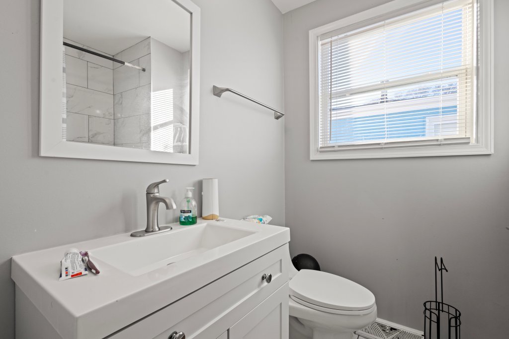 14564 Spaulding Avenue Harvey, IL 60426 - Photo 9 of 20 a bathroom with a sink a toilet and a window