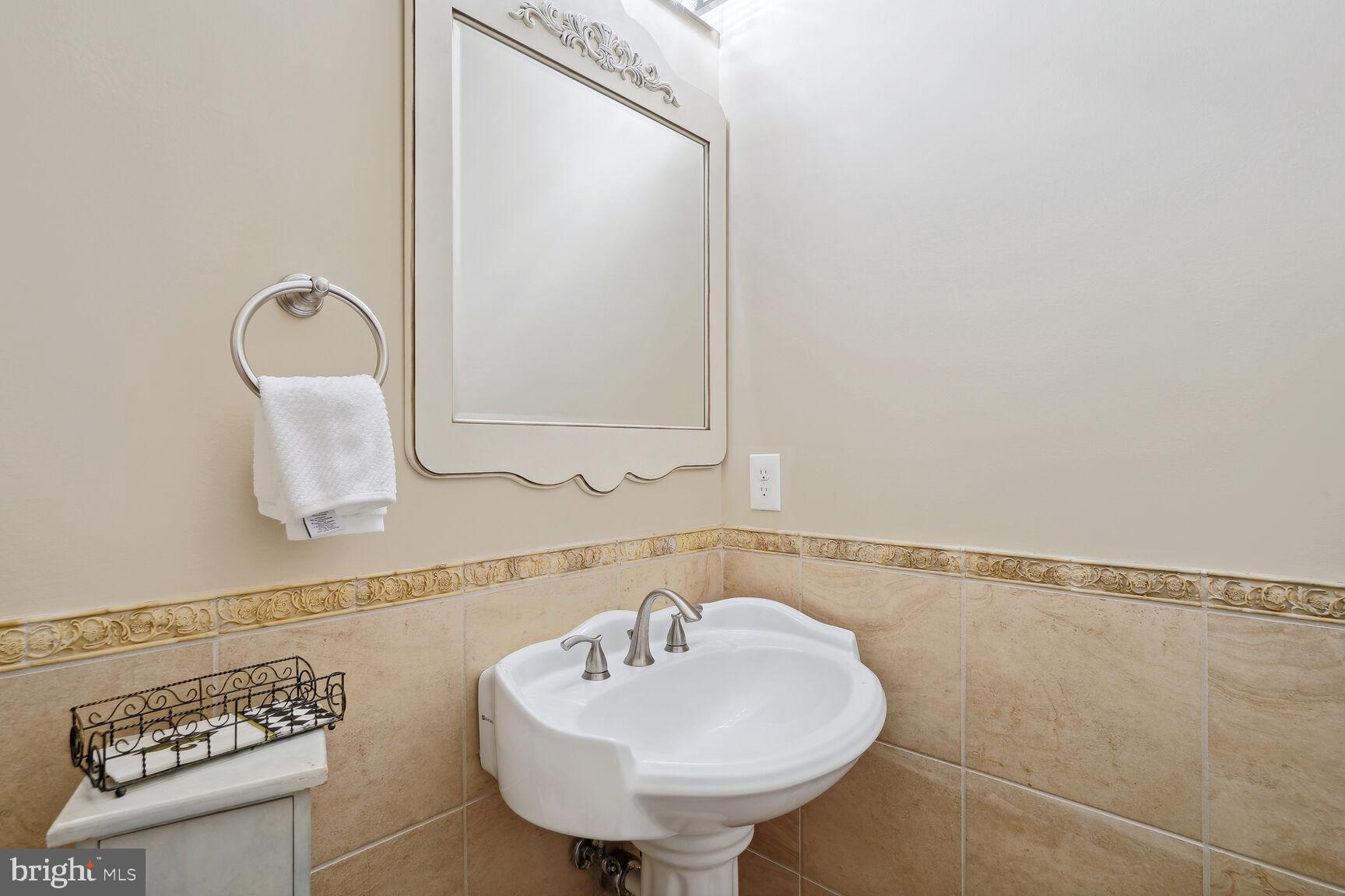 10813 Lockland Road Potomac, MD 20854 - Photo 12 of 73 a bathroom with a sink and a mirror