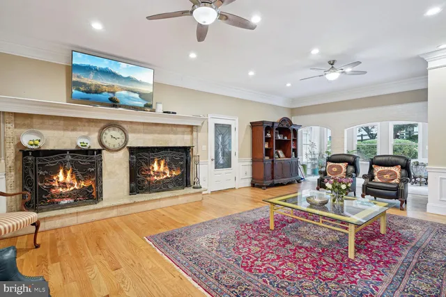 a living room with furniture and floor to ceiling windows