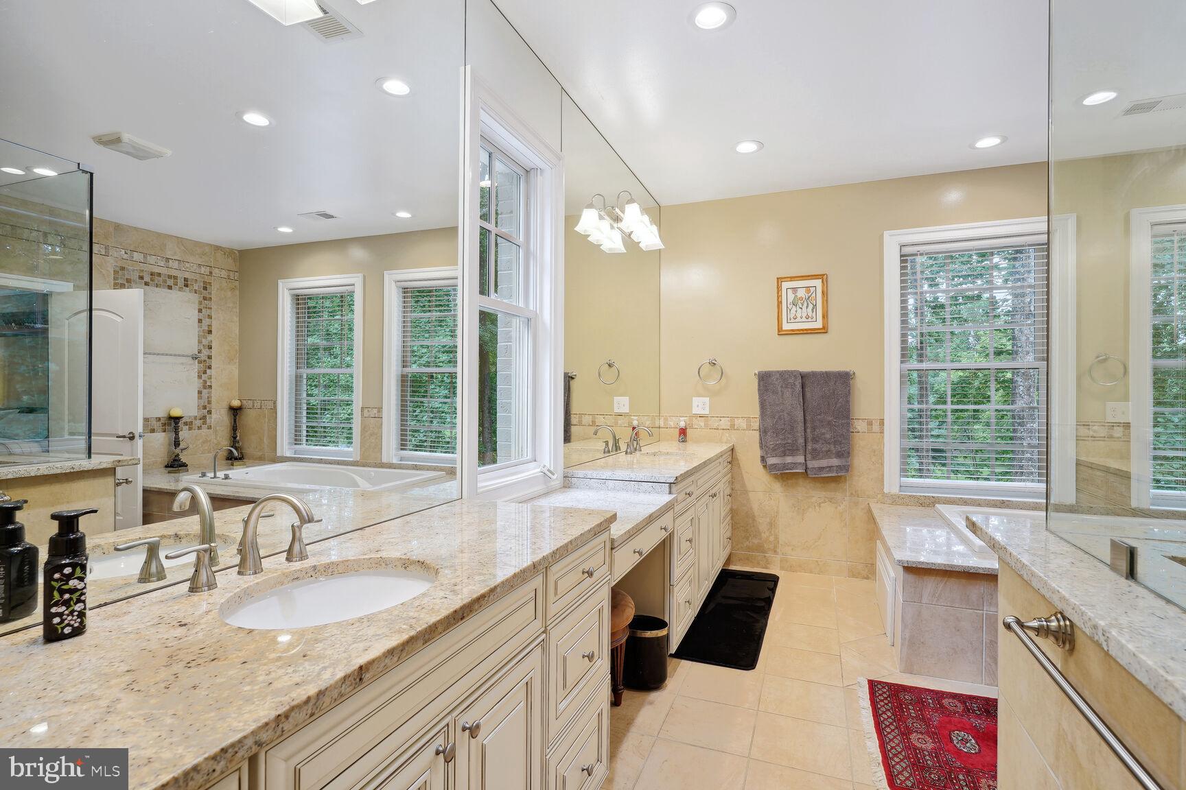 10813 Lockland Road Potomac, MD 20854 - Photo 37 of 73 a large bathroom with double vanity and a large mirror