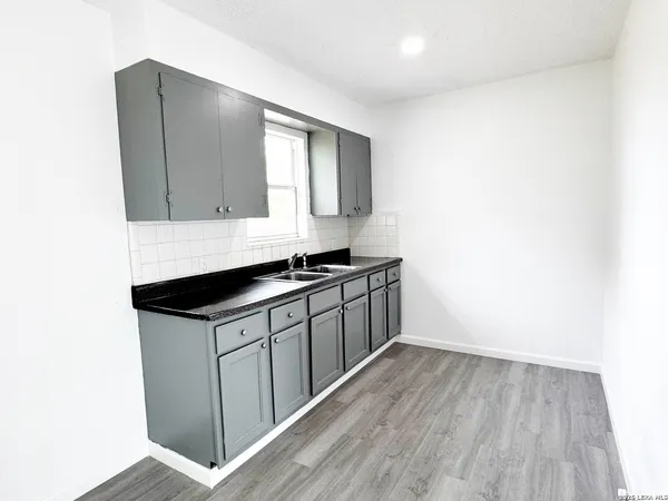 a kitchen with a sink and cabinets