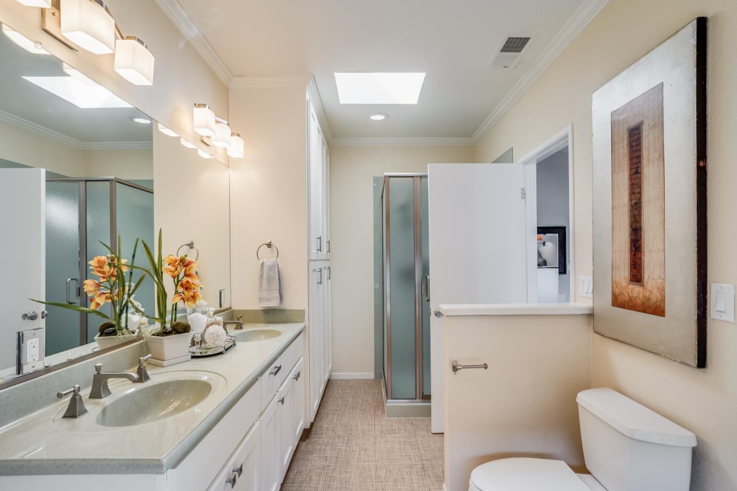 1684 Zinnia Lane San Jose, CA 95124 - Photo 19 of 33 a bathroom with a granite countertop sink toilet a large mirror a vanity and shower