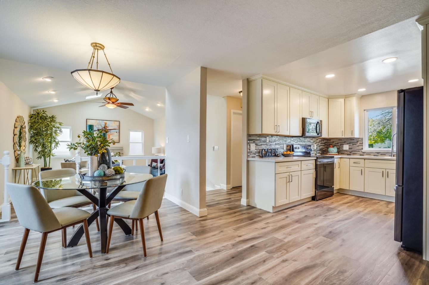 1684 Zinnia Lane San Jose, CA 95124 - Photo 5 of 33 a kitchen with a table chairs refrigerator and cabinets