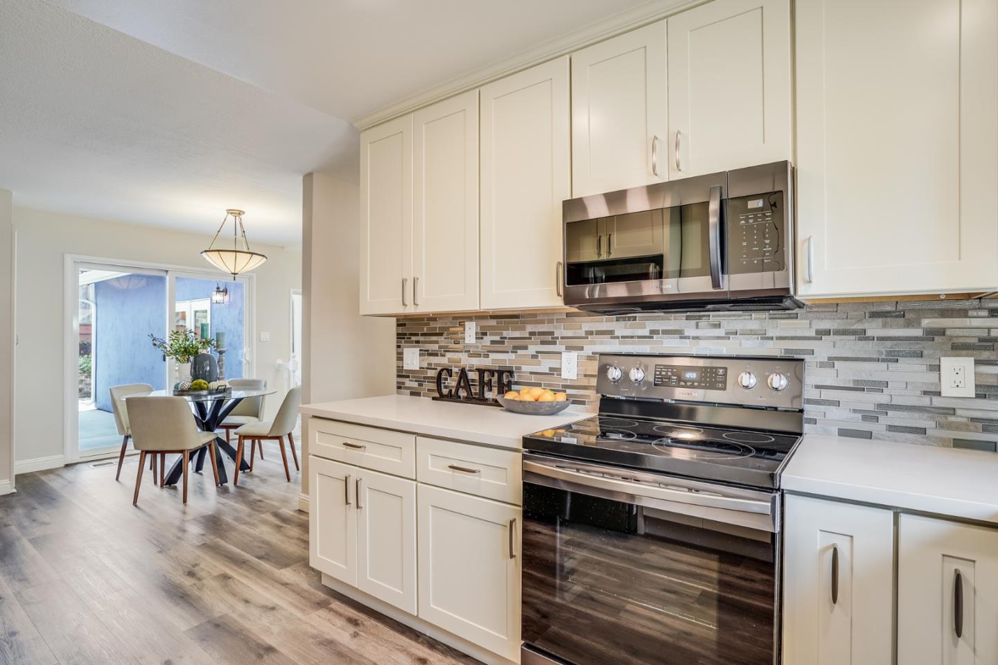 1684 Zinnia Lane San Jose, CA 95124 - Photo 8 of 33 a kitchen with stainless steel appliances granite countertop a stove a sink a microwave and white cabinets