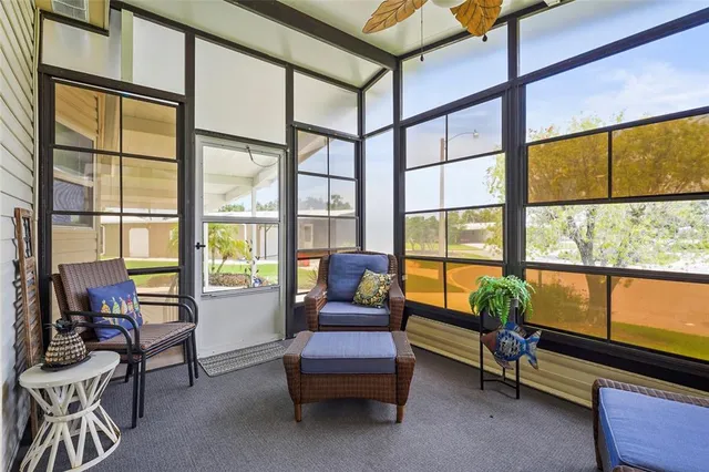 a spacious bedroom with a bed a dresser and a chandelier