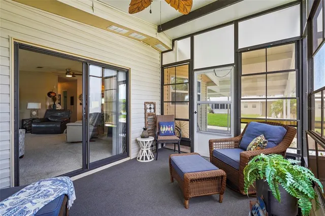 a bedroom with bed tv and a window