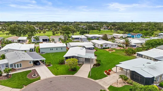 a view of a house with a yard and tree s
