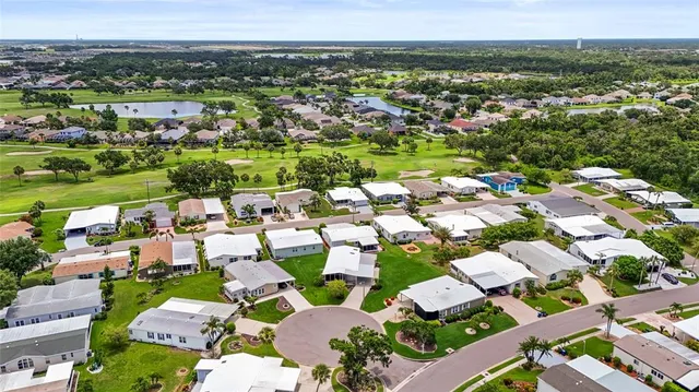 a front view of a house with a yard and a garage