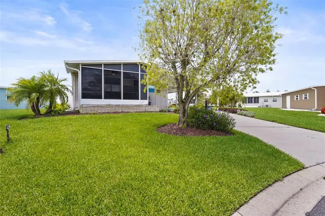 a view of a house with a big yard and potted plants