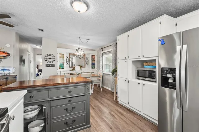 a living room with furniture a clock and a window