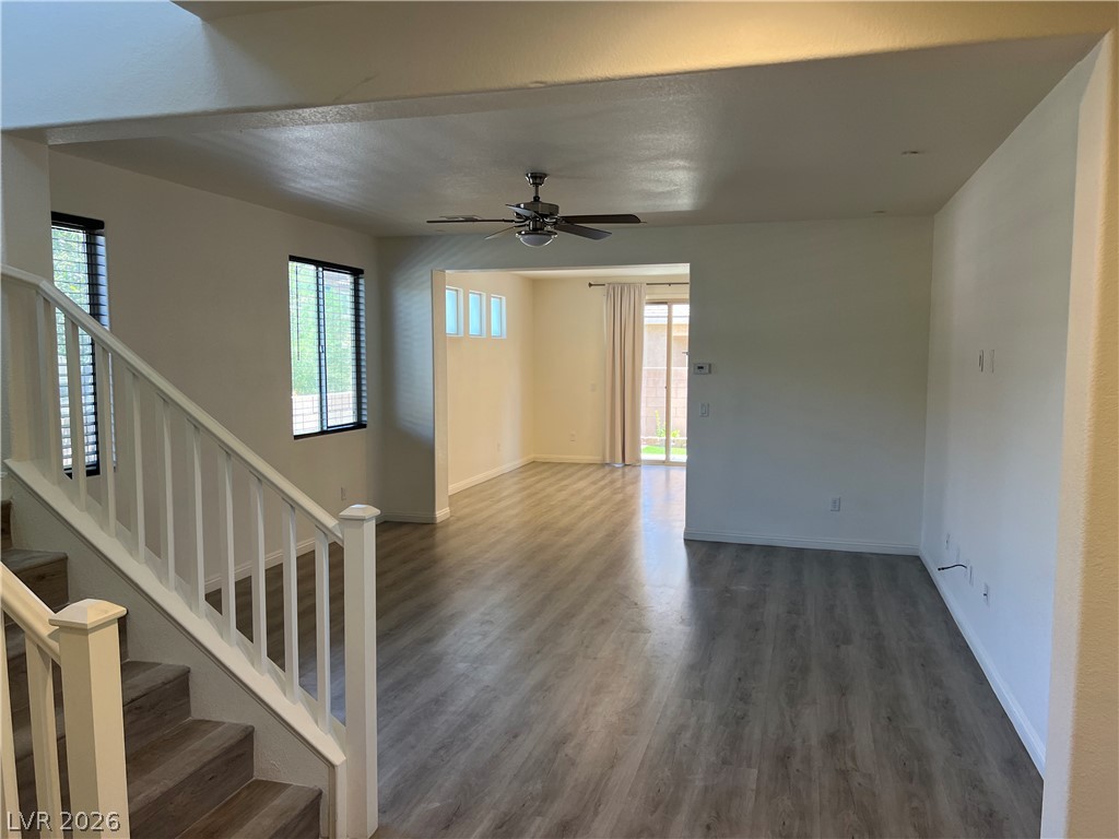 9581 Aberdeen Ridge Court Las Vegas, NV 89148 - Photo 4 of 25 A spacious living area with resilient wood-look flooring and a versatile ceiling fan.