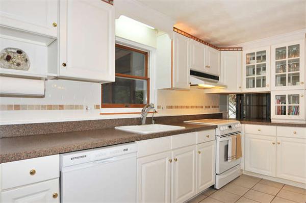11 Doris Road Framingham, MA 01701 - Photo 6 of 21 a kitchen with granite countertop white cabinets and white appliances
