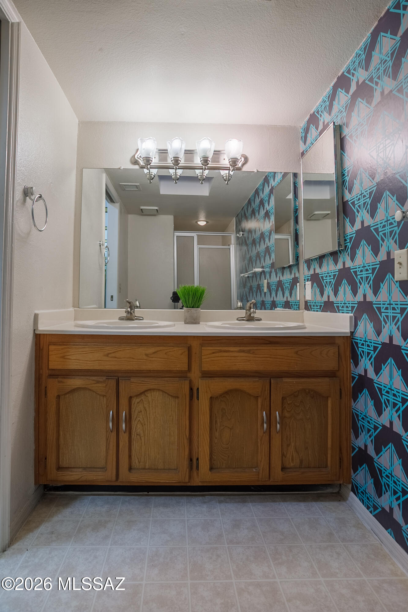 1200 East River Road, Unit B27 Tucson, AZ 85718 - Photo 32 of 40 a bathroom with a double vanity sink and a mirror