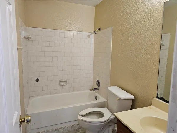 an empty room with a window and a ceiling fan