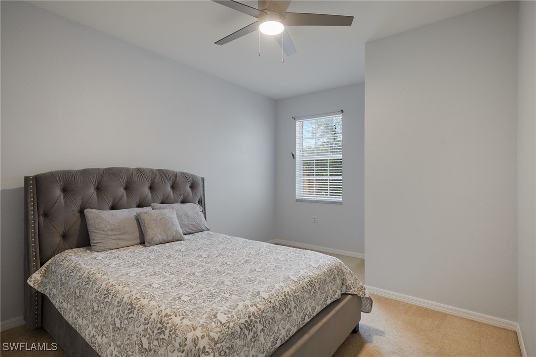 4381 Lazio Way, Unit 504 Fort Myers, FL 33901 - Photo 15 of 21 a bedroom with a bed and window