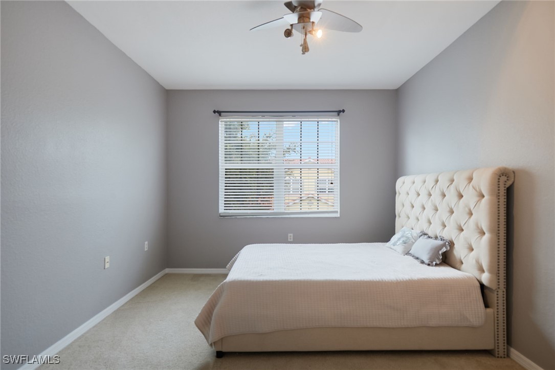 4381 Lazio Way, Unit 504 Fort Myers, FL 33901 - Photo 16 of 21 a bedroom with a bed and window