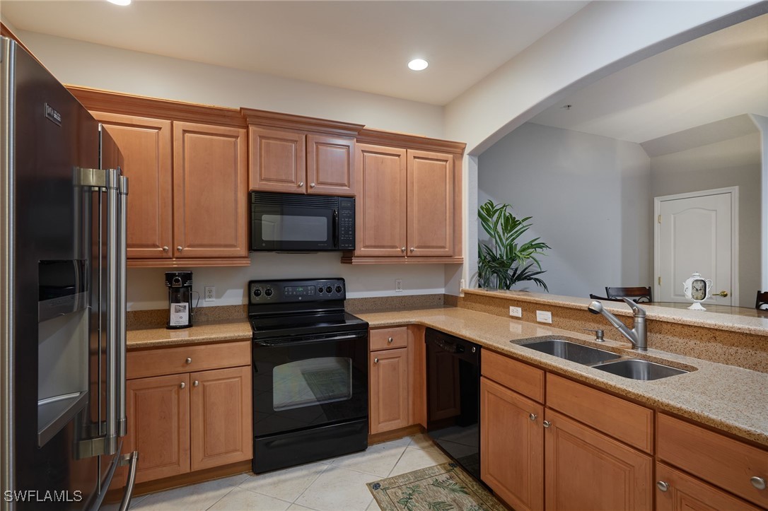 4381 Lazio Way, Unit 504 Fort Myers, FL 33901 - Photo 2 of 21 a kitchen with a sink stove and microwave