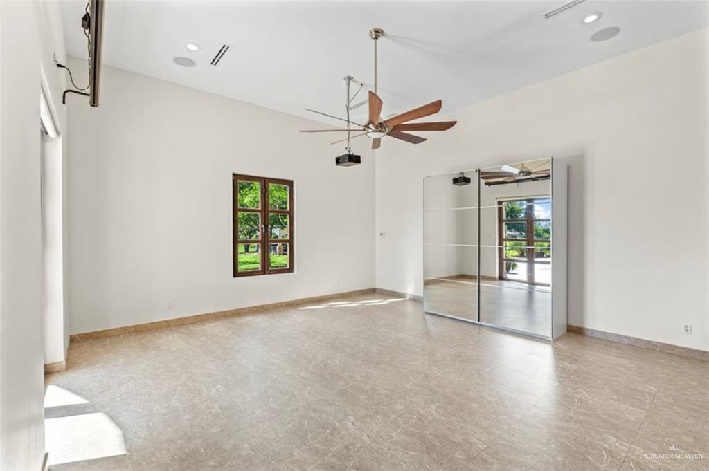 1425 Encanto Road, Unit SERVICE Weslaco, TX 78596 - Photo 15 of 45 Unfurnished room with healthy amount of natural light, french doors, recessed lighting, and ceiling fan