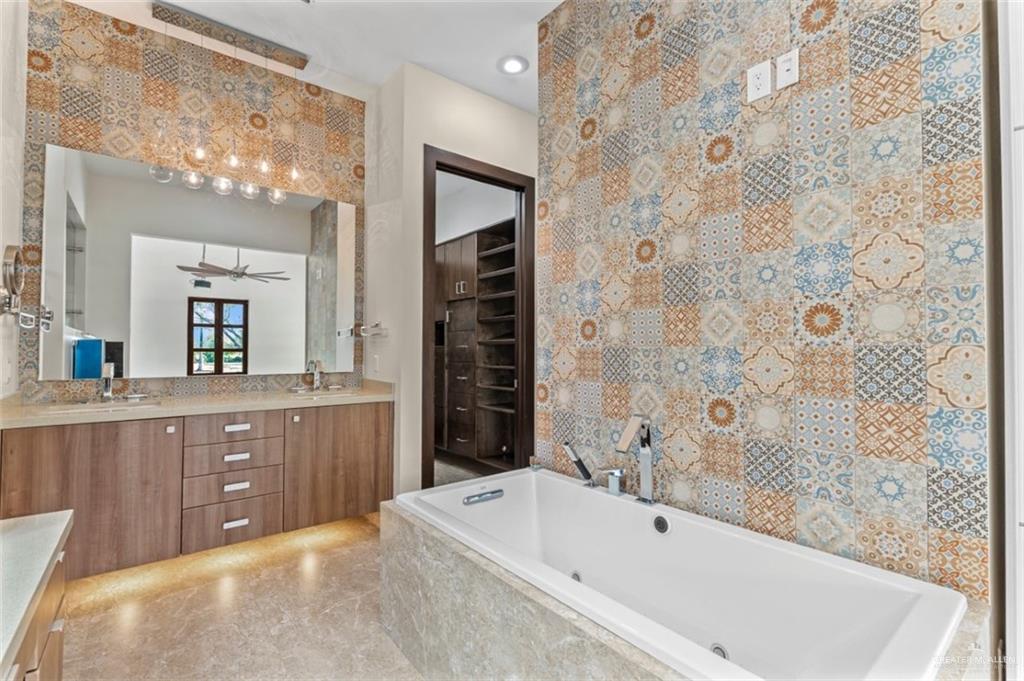 1425 Encanto Road, Unit SERVICE Weslaco, TX 78596 - Photo 17 of 45 Full bathroom featuring double vanity, a tub with jets, and recessed lighting