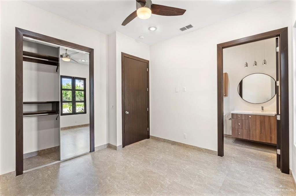 1425 Encanto Road, Unit SERVICE Weslaco, TX 78596 - Photo 21 of 45 Unfurnished bedroom featuring recessed lighting, a ceiling fan, a closet, and ensuite bath