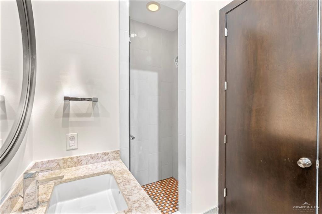 1425 Encanto Road, Unit SERVICE Weslaco, TX 78596 - Photo 24 of 45 Bathroom featuring a shower stall and vanity