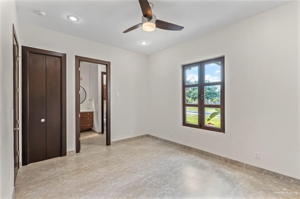 1425 Encanto Road, Unit SERVICE Weslaco, TX 78596 - Photo 25 of 45 Unfurnished bedroom featuring connected bathroom, a ceiling fan, and recessed lighting