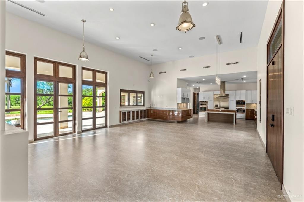 1425 Encanto Road, Unit SERVICE Weslaco, TX 78596 - Photo 32 of 45 Unfurnished living room with a high ceiling and recessed lighting